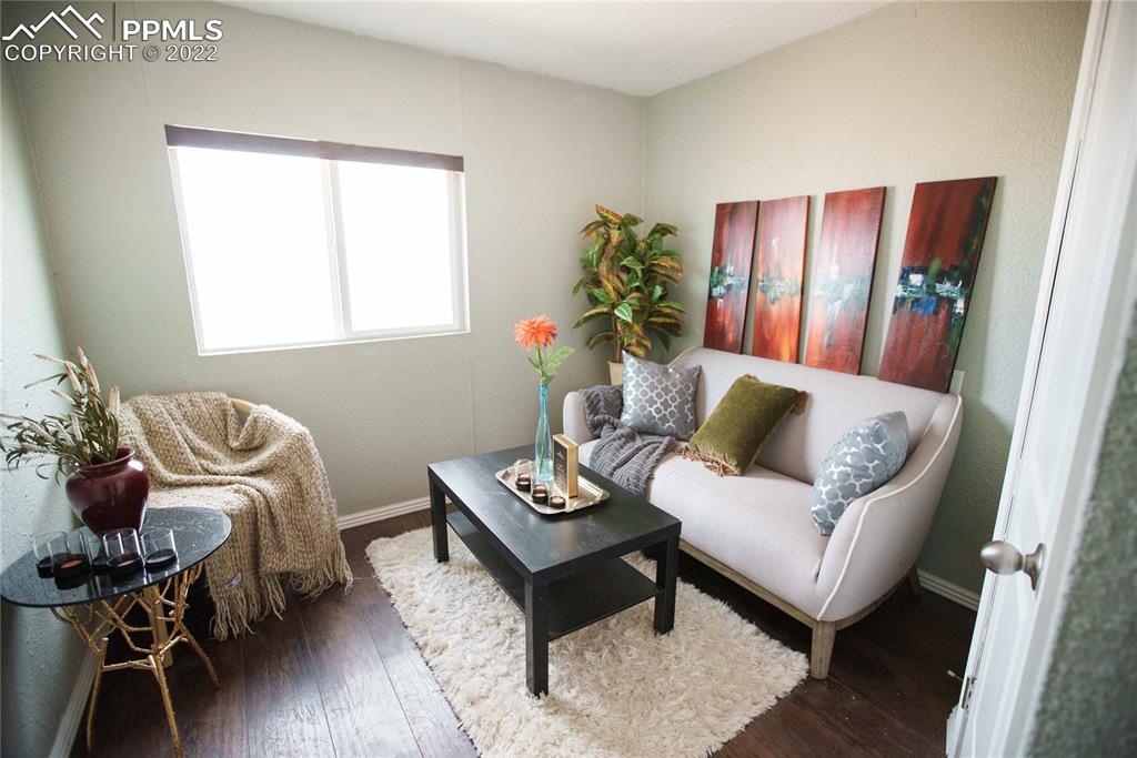 6605 Lauppe Road Yoder, CO 80864 - Photo 16 of 38 a living room with furniture and wooden floor