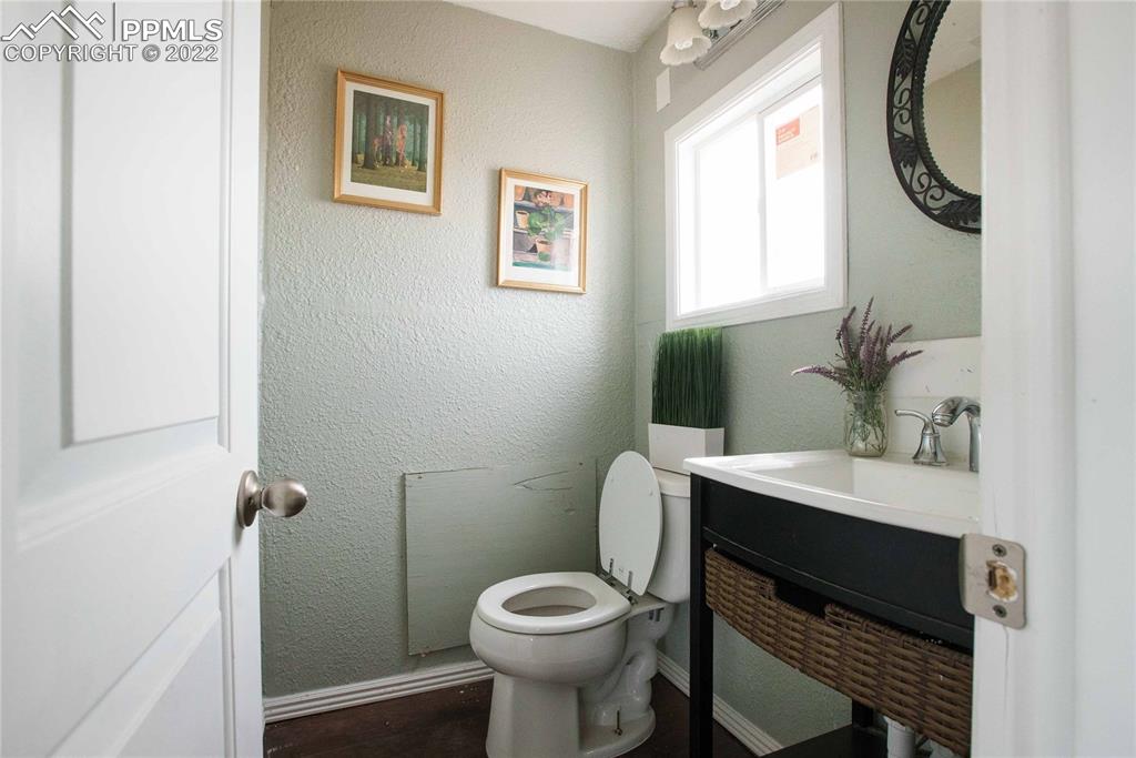 6605 Lauppe Road Yoder, CO 80864 - Photo 19 of 38 a bathroom with a sink toilet and a mirror