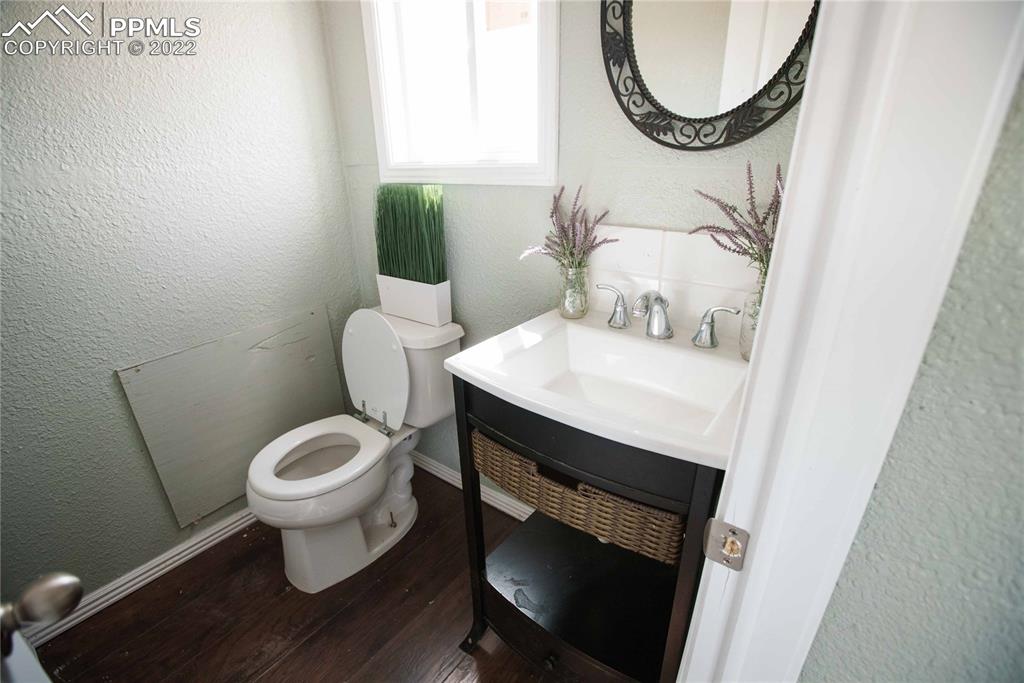 6605 Lauppe Road Yoder, CO 80864 - Photo 20 of 38 a bathroom with a toilet a sink and a mirror