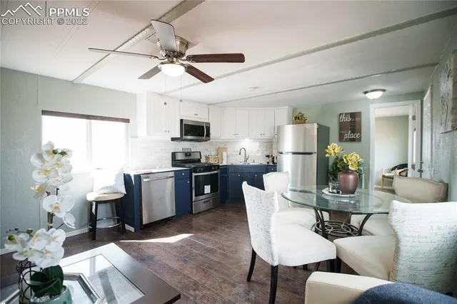 a living room with fireplace furniture and a chandelier