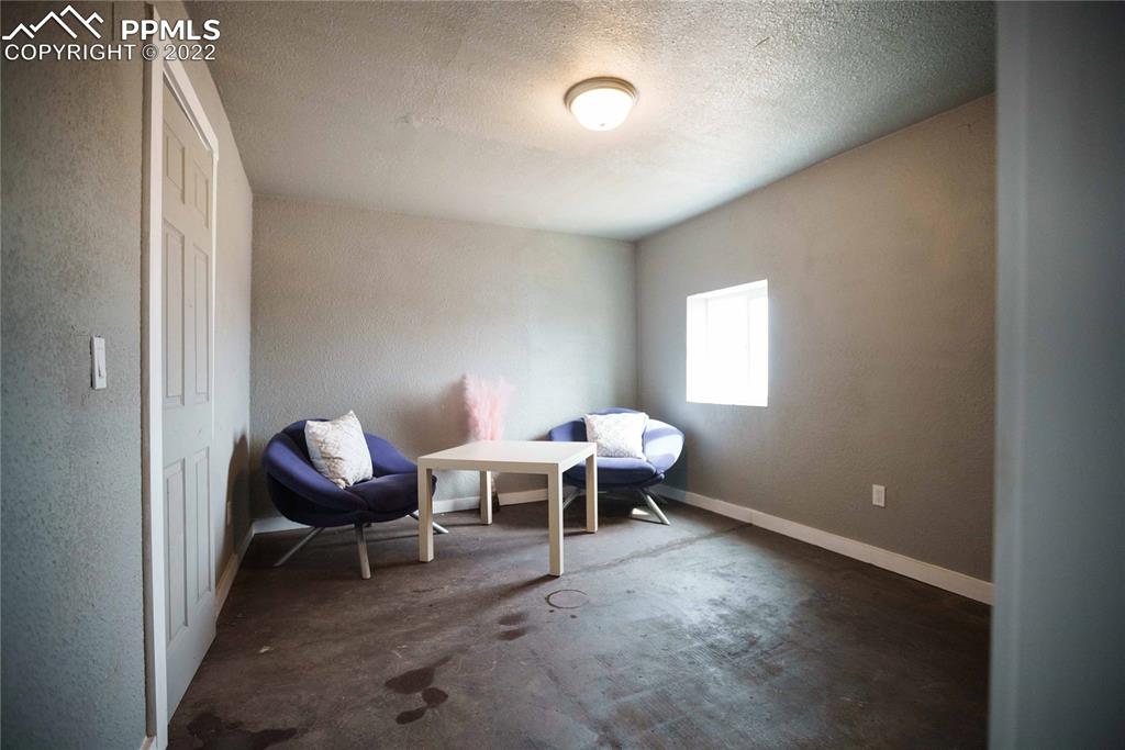 6605 Lauppe Road Yoder, CO 80864 - Photo 22 of 38 a living room with furniture a table and a window