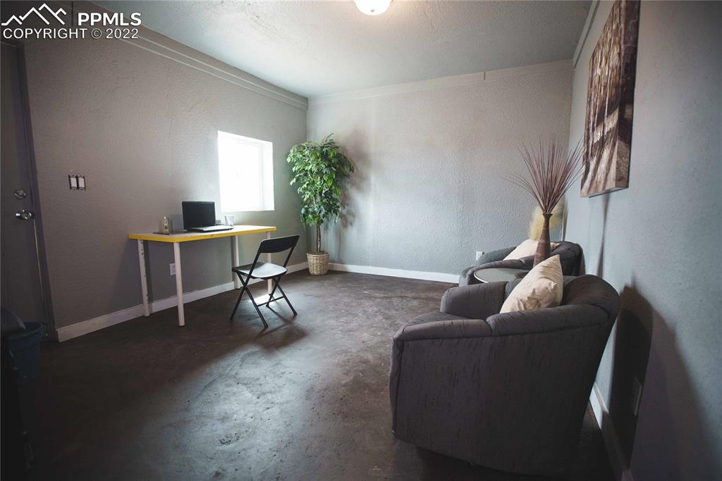 6605 Lauppe Road Yoder, CO 80864 - Photo 23 of 38 a living room with furniture and a potted plant