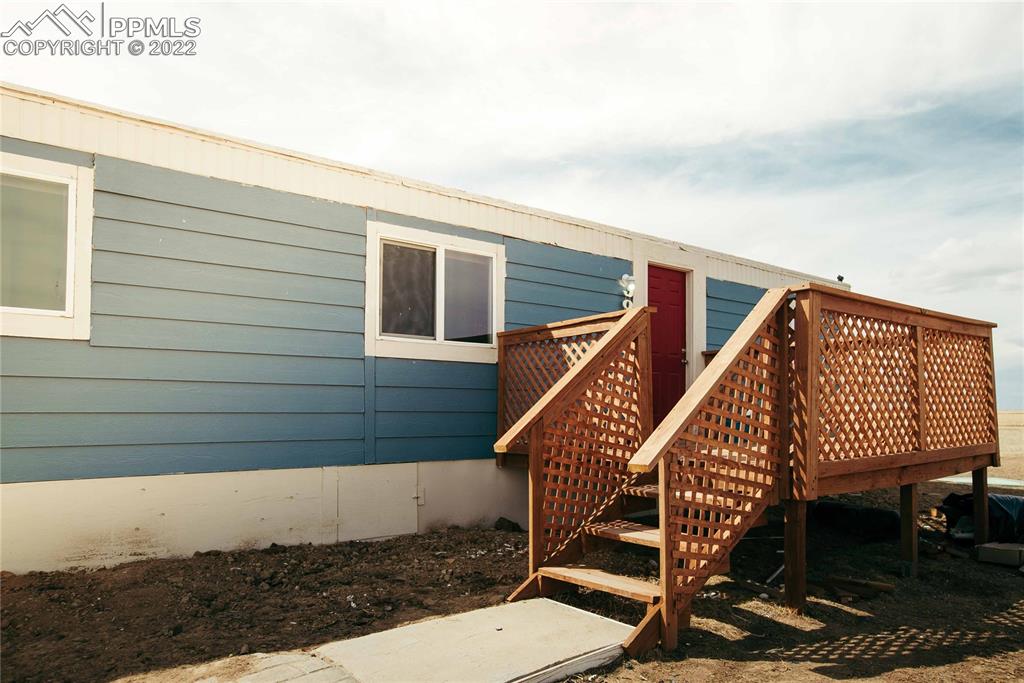 6605 Lauppe Road Yoder, CO 80864 - Photo 27 of 38 a view of a roof deck with wooden floor and fence