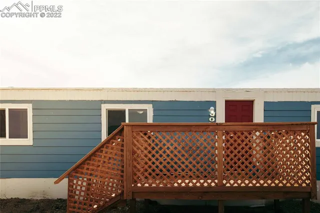 a view of a house with wooden fence