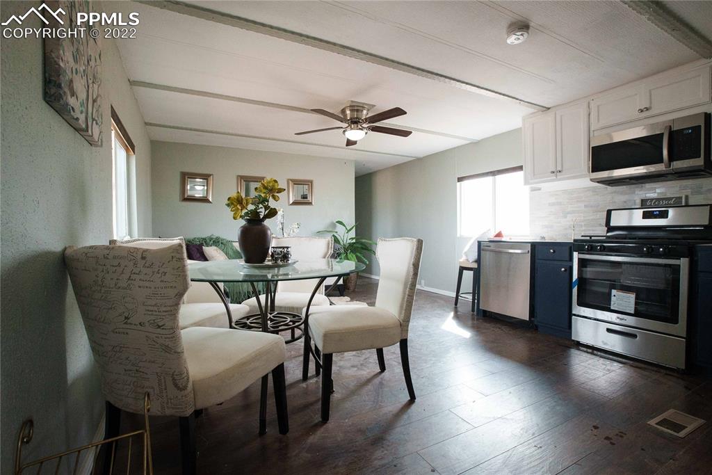 6605 Lauppe Road Yoder, CO 80864 - Photo 6 of 38 a dining room with furniture and wooden floor