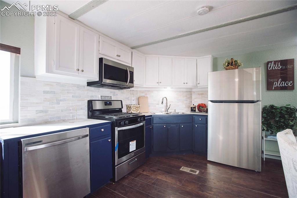 6605 Lauppe Road Yoder, CO 80864 - Photo 7 of 38 a kitchen with stainless steel appliances granite countertop a refrigerator stove a sink dishwasher and a microwave