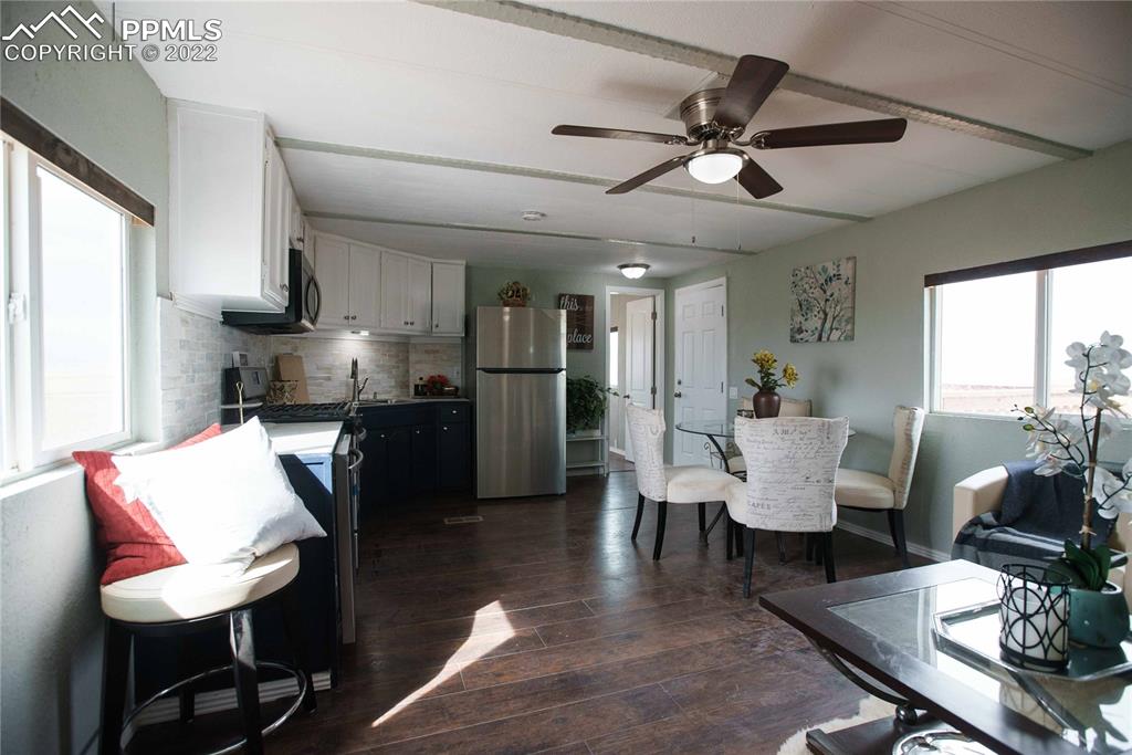 6605 Lauppe Road Yoder, CO 80864 - Photo 8 of 38 a living room with furniture kitchen view and a chandelier