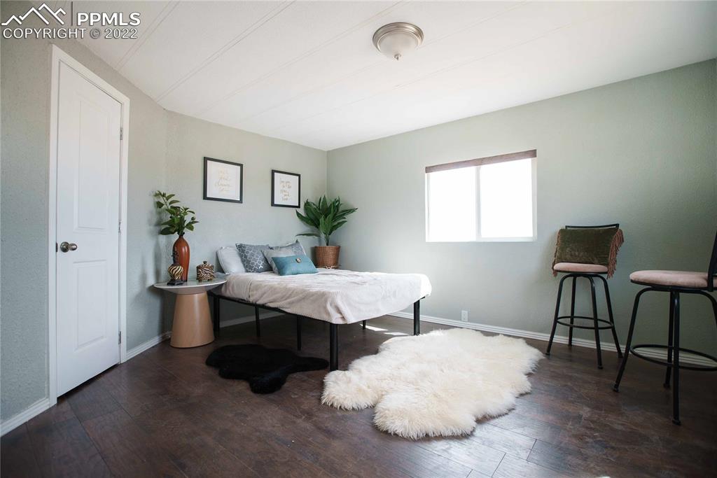 6605 Lauppe Road Yoder, CO 80864 - Photo 10 of 38 a living room with furniture and a wooden floor