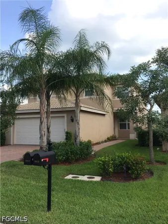 a front view of house with yard and green space