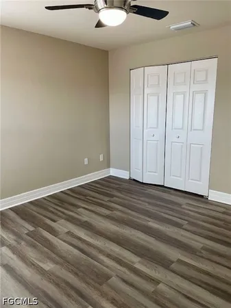 a view of a hallway with wooden floor and door