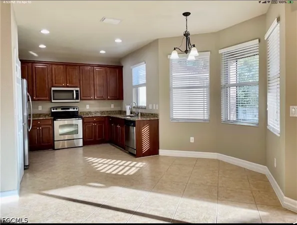 a kitchen with stainless steel appliances granite countertop a stove sink and cabinets