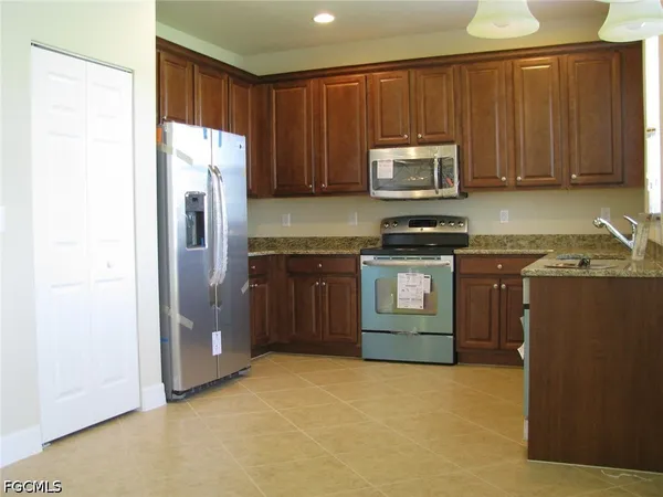 a kitchen with a sink stove and refrigerator