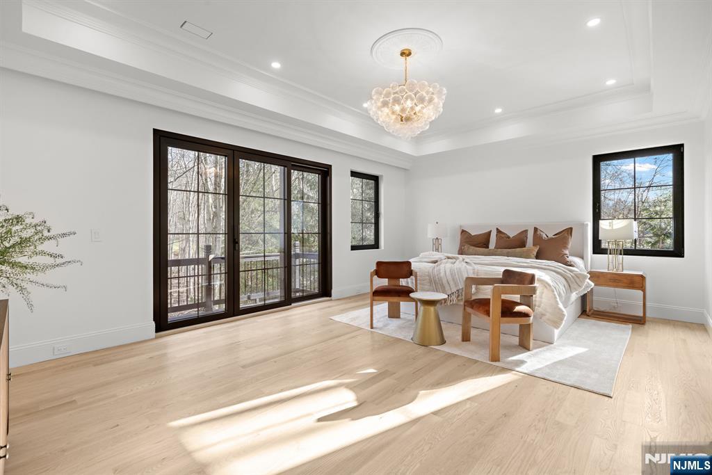 16 Old Farms Road Saddle River, NJ 07458 - Photo 16 of 31 a spacious bedroom with a bed and a chandelier