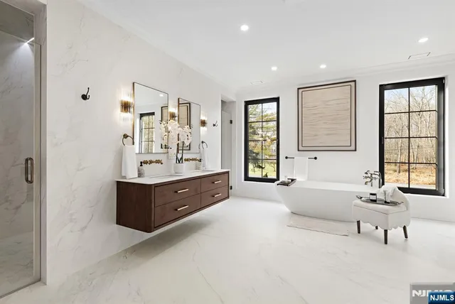 a bathroom with a double vanity sink toilet and shower