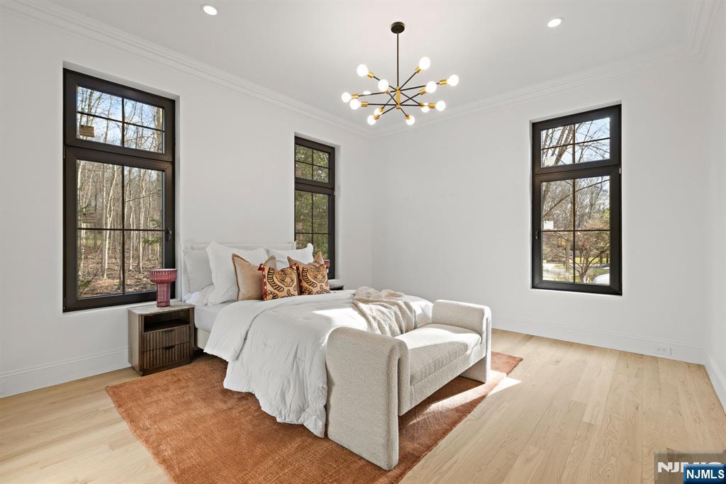 16 Old Farms Road Saddle River, NJ 07458 - Photo 20 of 31 a bedroom with a bed chandelier and window