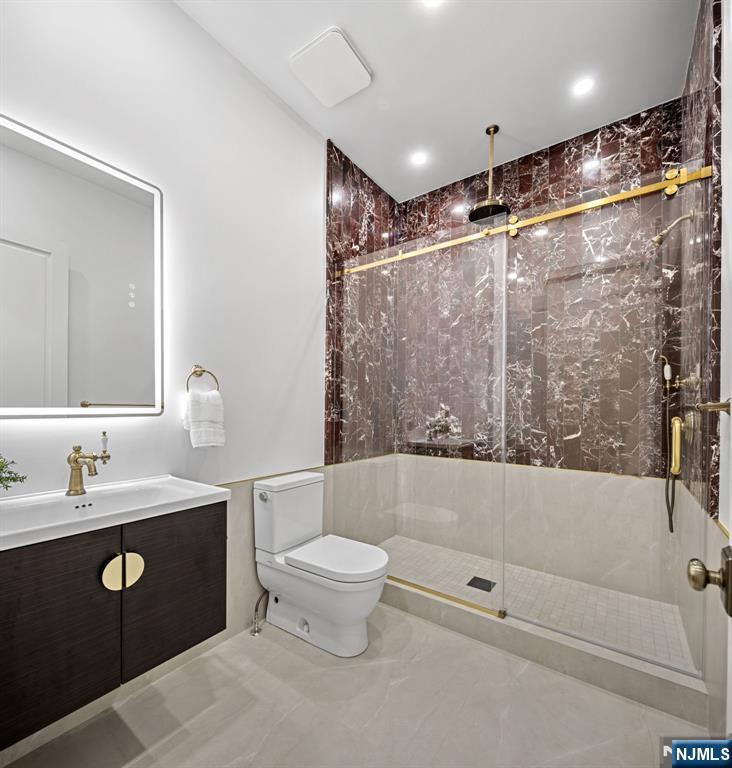 16 Old Farms Road Saddle River, NJ 07458 - Photo 21 of 31 a bathroom with a double vanity sink toilet and shower