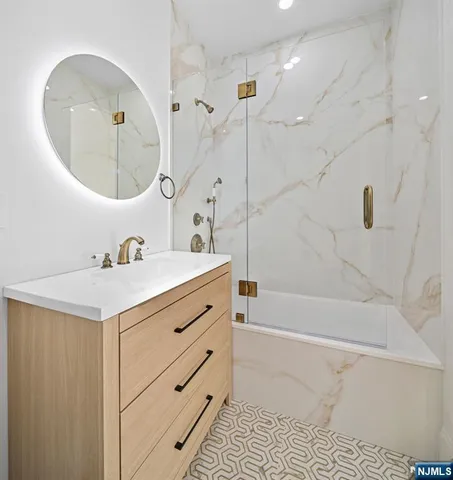 a bathroom with a sink mirror vanity and toilet