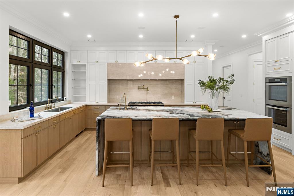 16 Old Farms Road Saddle River, NJ 07458 - Photo 5 of 31 a large kitchen with a table and chairs in it