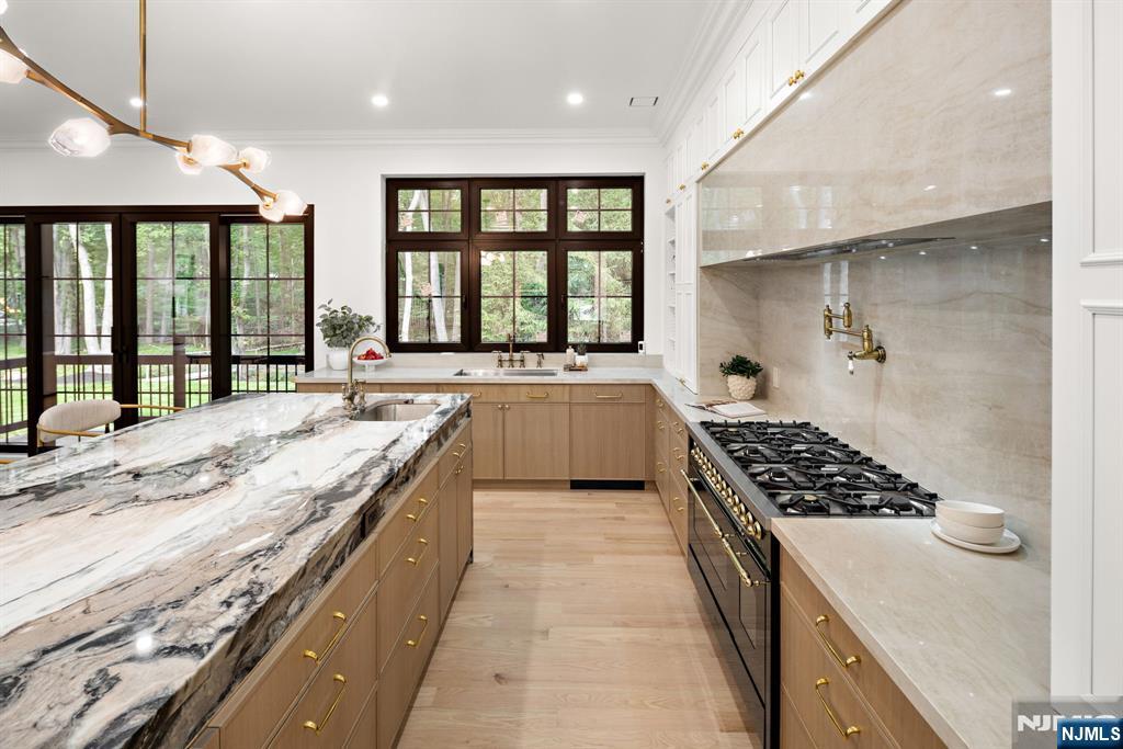 16 Old Farms Road Saddle River, NJ 07458 - Photo 6 of 31 a large kitchen with granite countertop a sink and a stove top oven