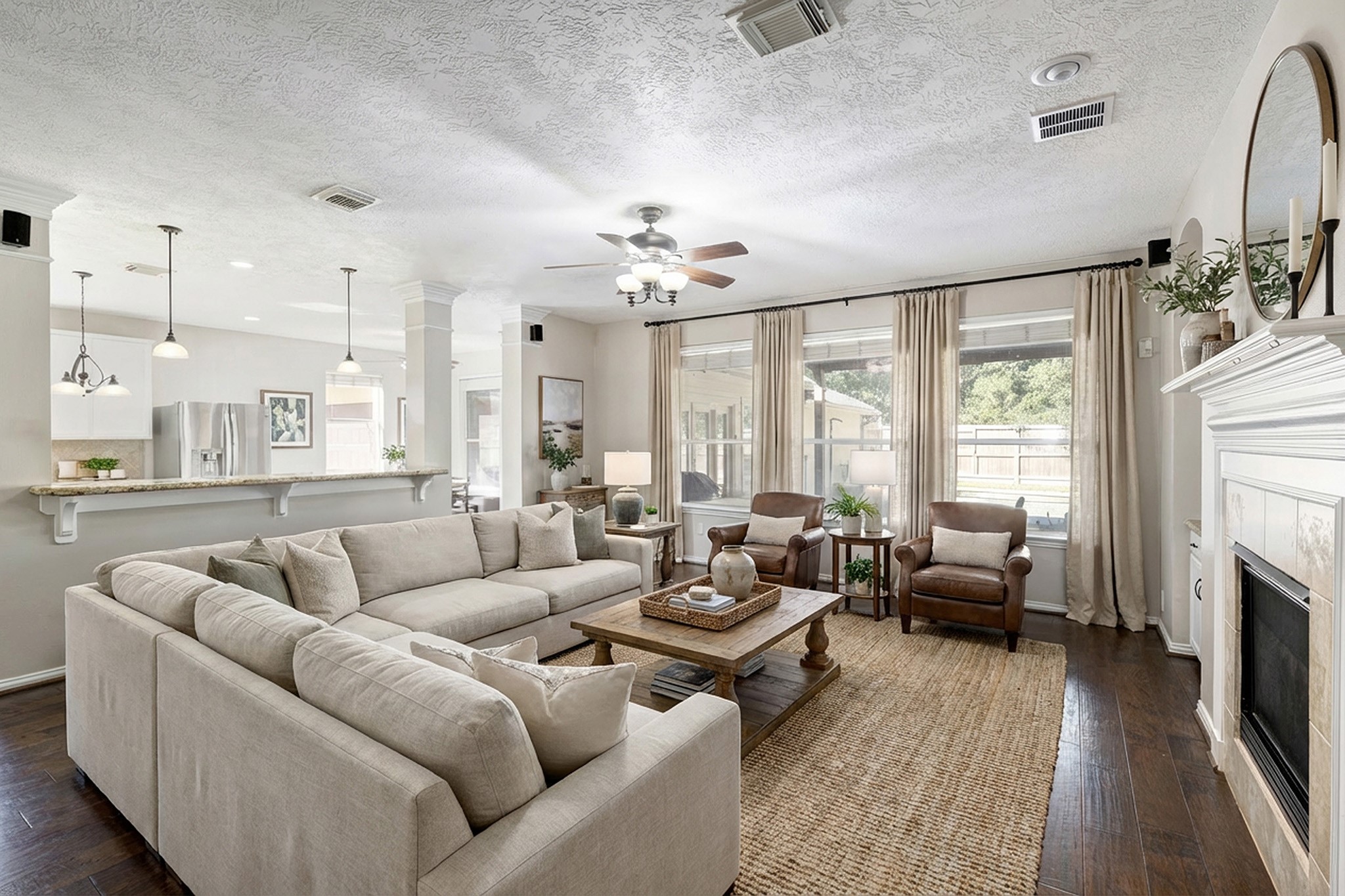 2511 Bridgestone Park Lane Spring, TX 77386 - Photo 6 of 25 The family room is centrally located to be the hub of the home. Engineered wood floors extend into this space with a fireplace and views to the kitchen and pool. This photo is virtually furnished.