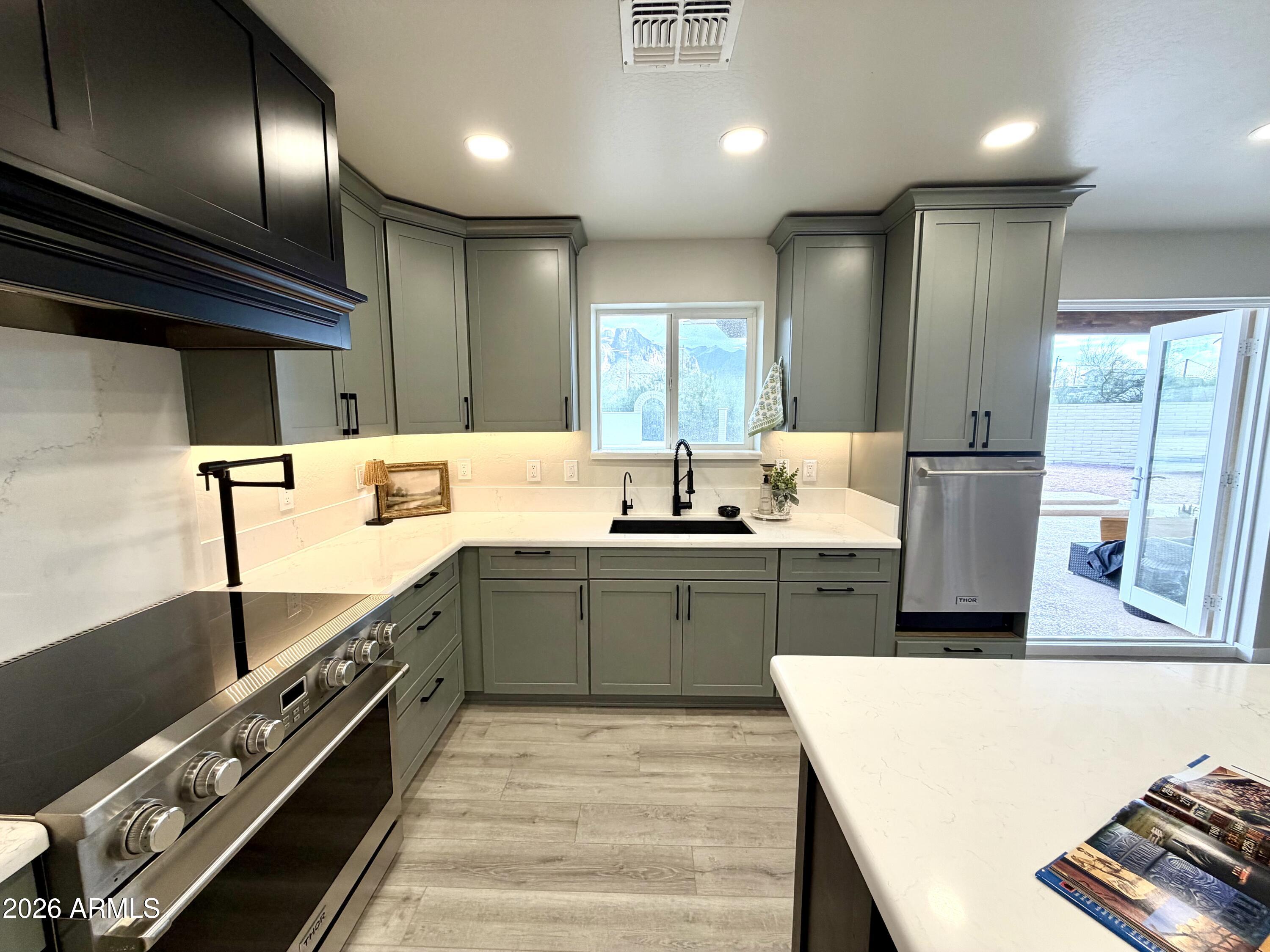 1165 North Mountain View Road Apache Junction, AZ 85119 - Photo 6 of 29 a large kitchen with stainless steel appliances kitchen island a large counter top