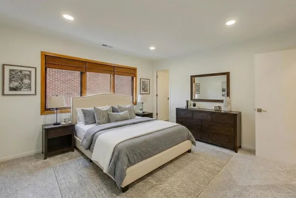 a bedroom with a bed and a dresser
