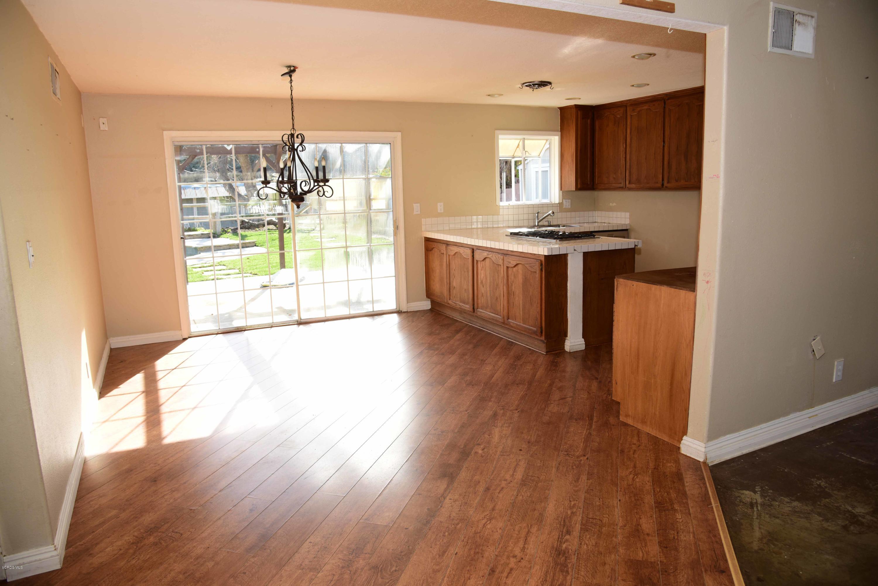 3314 Shenandoah Avenue Simi Valley, CA 93063 - Photo 2 of 7 a kitchen with kitchen island granite countertop wooden floors a stove and a granite counter top