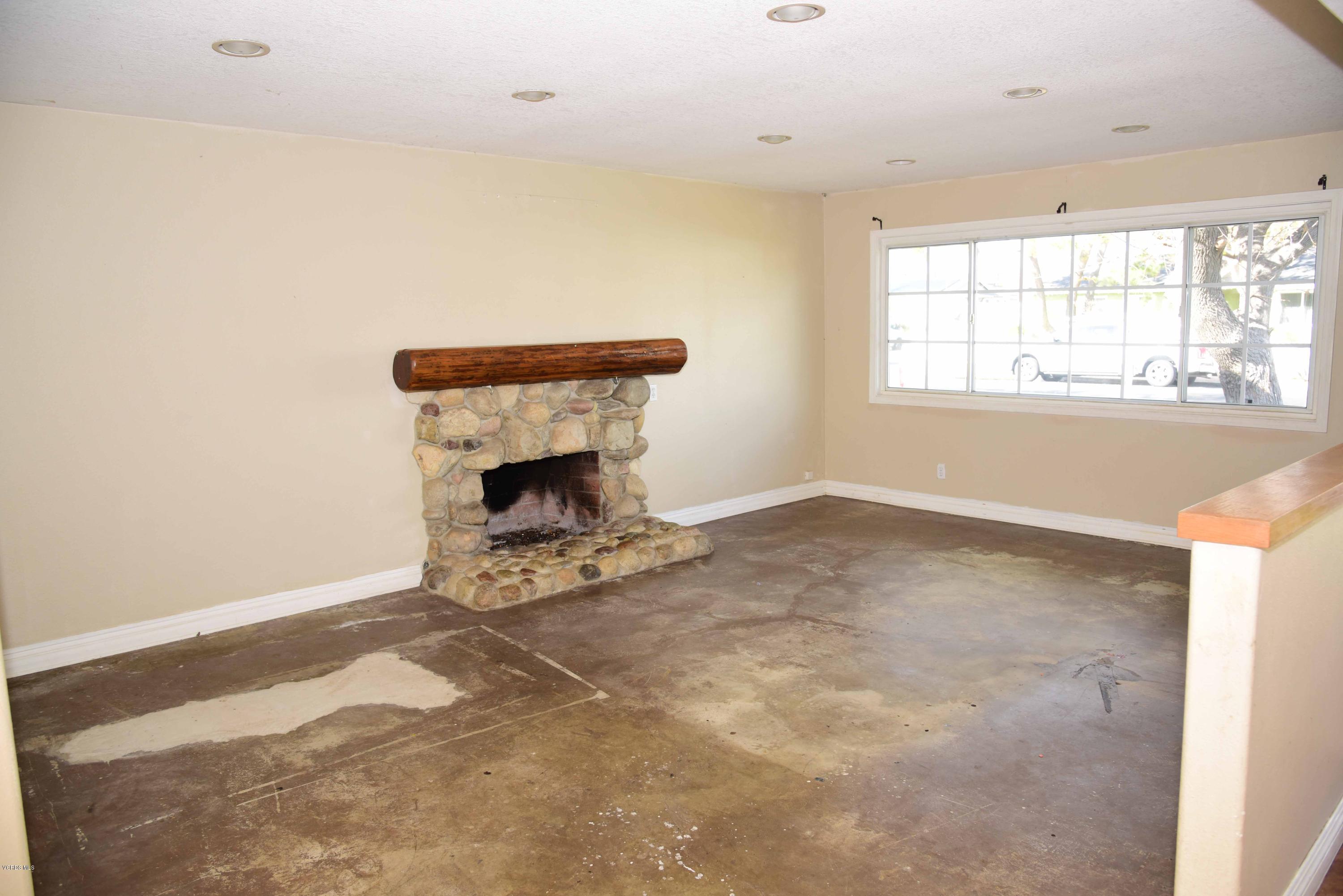 3314 Shenandoah Avenue Simi Valley, CA 93063 - Photo 5 of 7 an empty room with a fireplace and windows