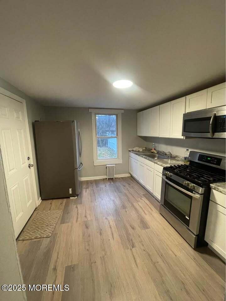 a kitchen with a stove a sink and a microwave