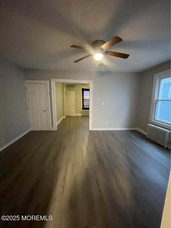 79 4th Avenue, Unit 1 Long Branch, NJ 07740 - Photo 2 of 11 an empty room with wooden floor and windows