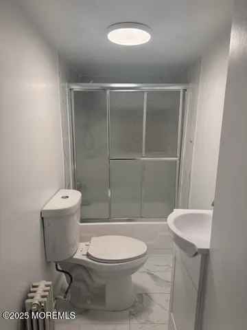 a bathroom with a toilet a sink and shower