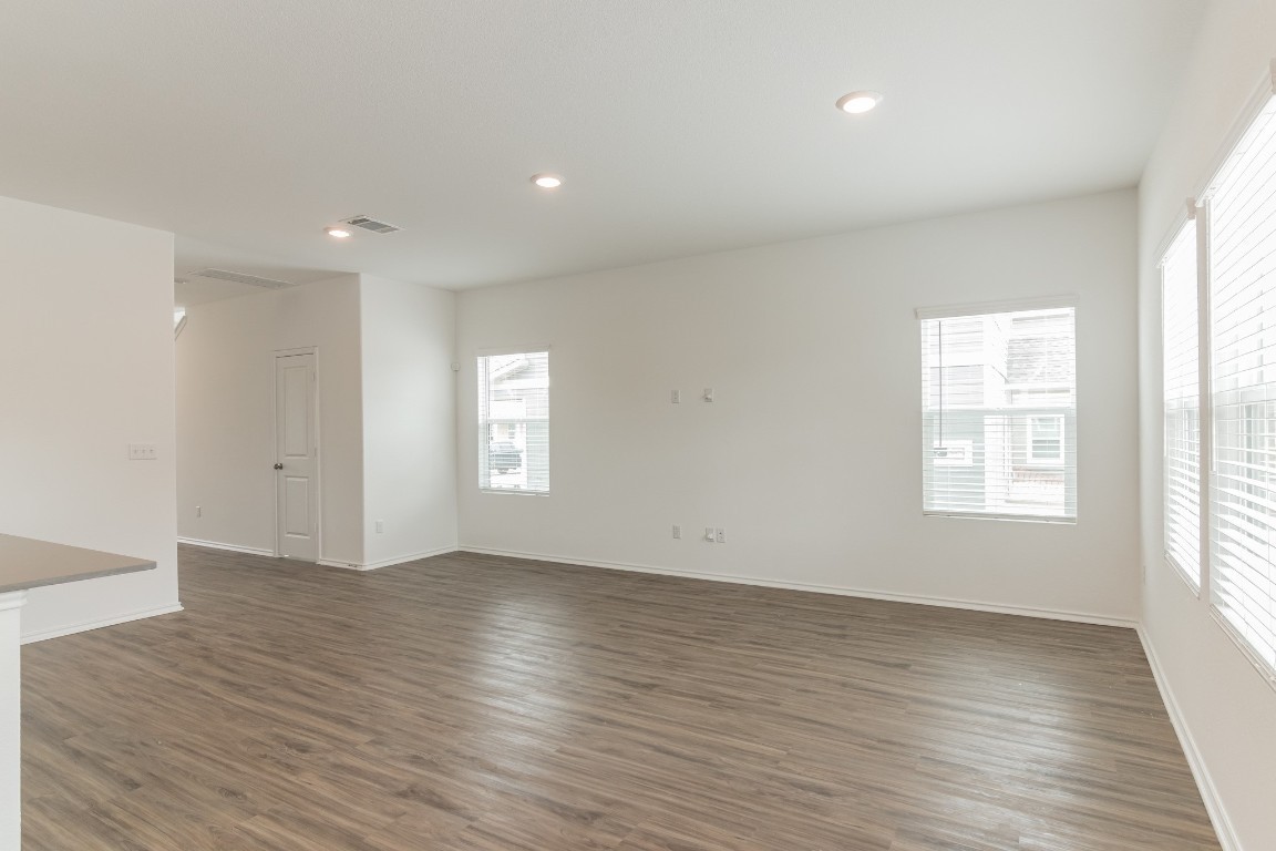 231 Rioja Kyle, TX 78640 - Photo 14 of 29 Empty room featuring recessed lighting and dark wood-type flooring