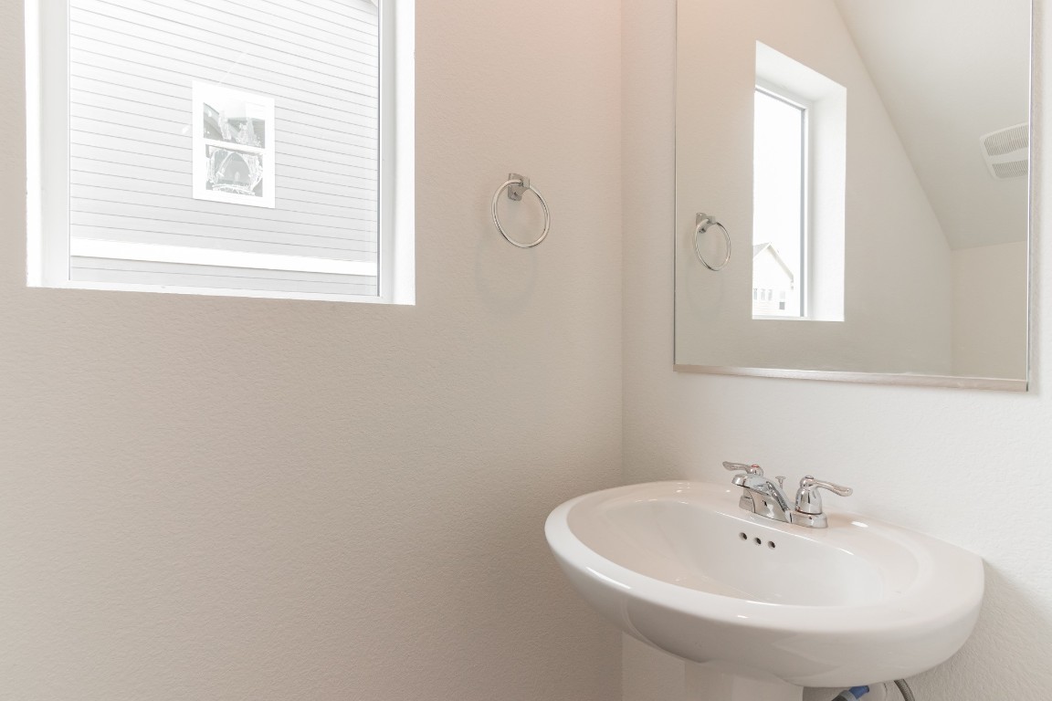 231 Rioja Kyle, TX 78640 - Photo 15 of 29 Bathroom with a sink and vaulted ceiling