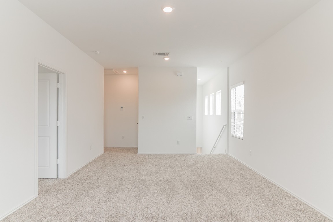 231 Rioja Kyle, TX 78640 - Photo 22 of 29 Unfurnished room featuring light colored carpet and recessed lighting