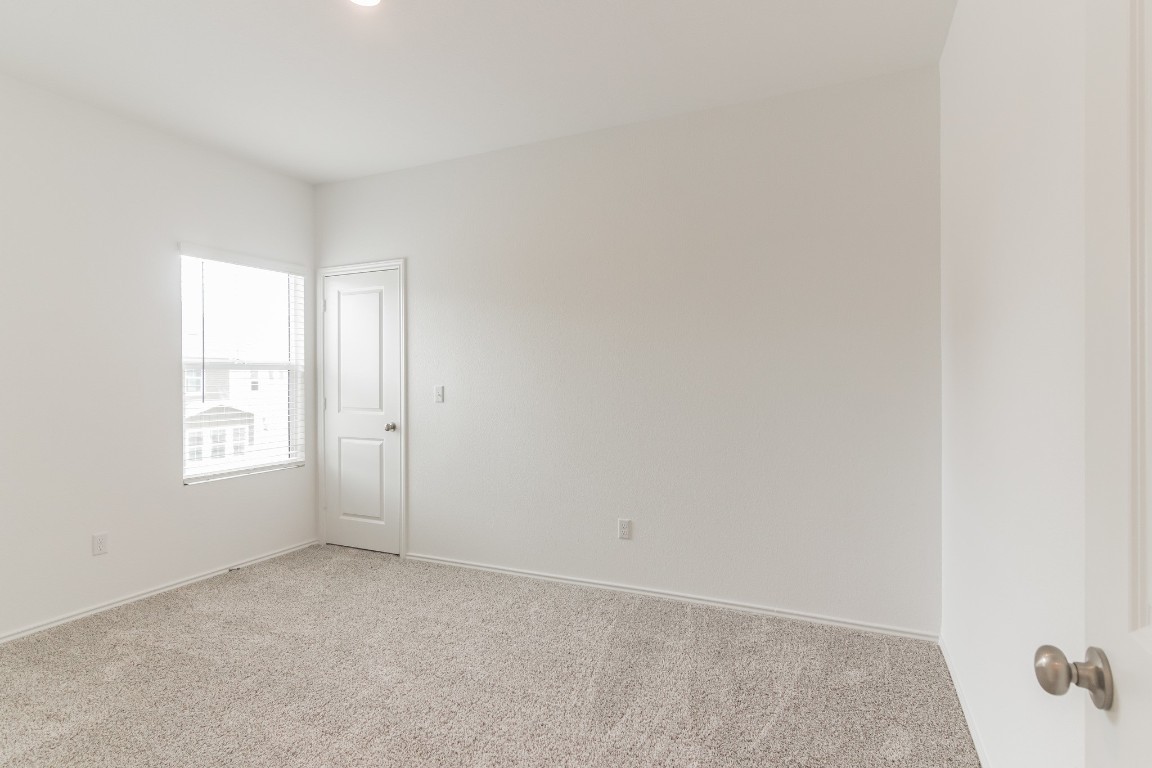 231 Rioja Kyle, TX 78640 - Photo 23 of 29 Spare room with light colored carpet and baseboards