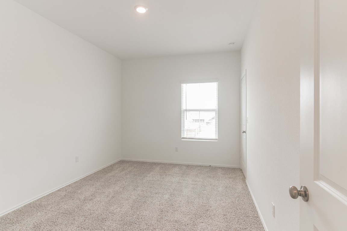 231 Rioja Kyle, TX 78640 - Photo 24 of 29 Empty room featuring light carpet and baseboards