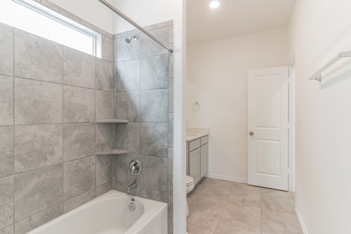 231 Rioja Kyle, TX 78640 - Photo 27 of 29 Full bathroom with vanity, shower / bathtub combination, and light tile patterned floors