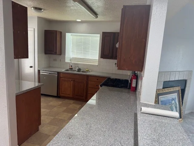 a kitchen with a sink window and cabinets
