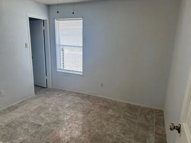 a bathroom with a granite countertop bathtub shower sink vanity and toilet