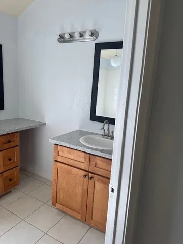 a bathroom with a sink a vanity and a mirror