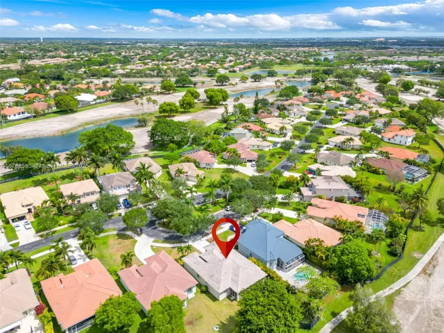 an aerial view of residential houses with outdoor space and street view