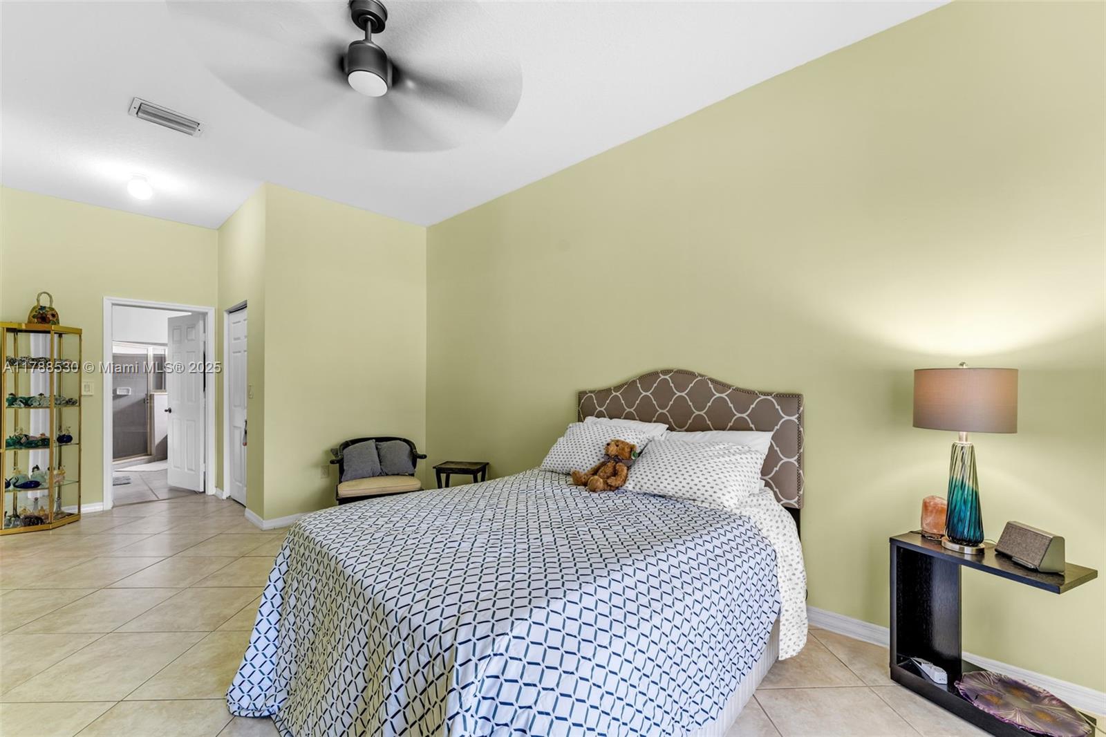 2819 Augusta Lane Homestead, FL 33035 - Photo 12 of 24 a bedroom with a bed and a lamp