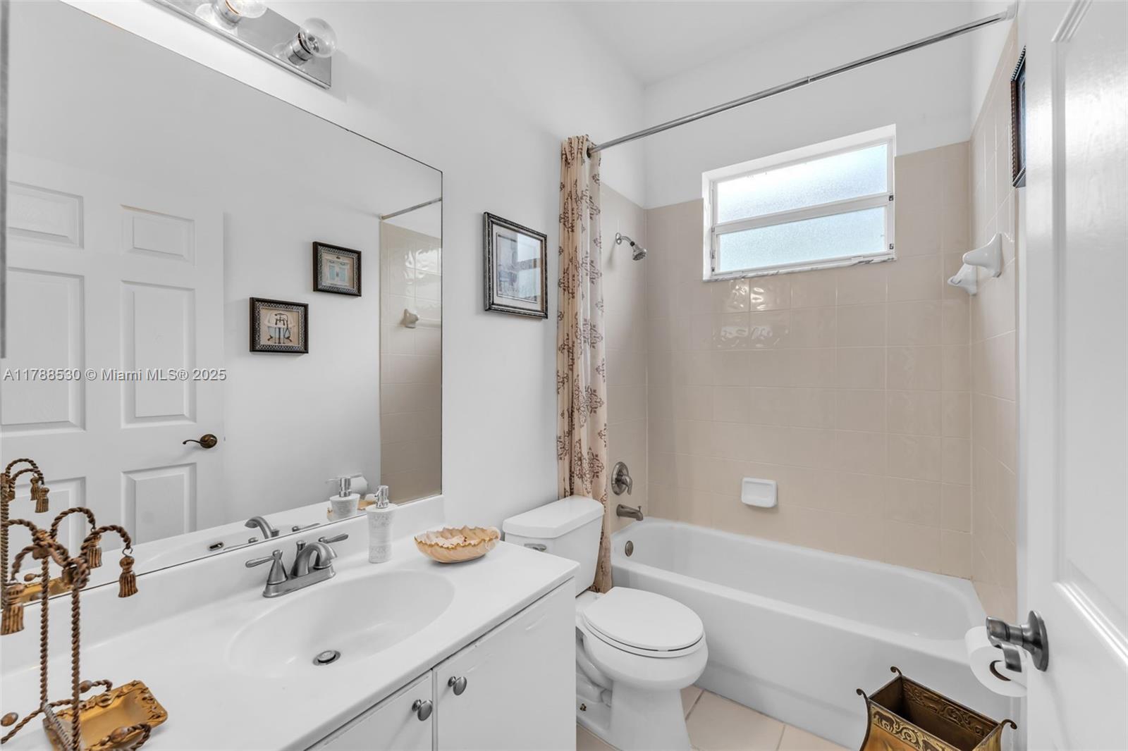 2819 Augusta Lane Homestead, FL 33035 - Photo 16 of 24 a bathroom with a sink mirror toilet and bathtub