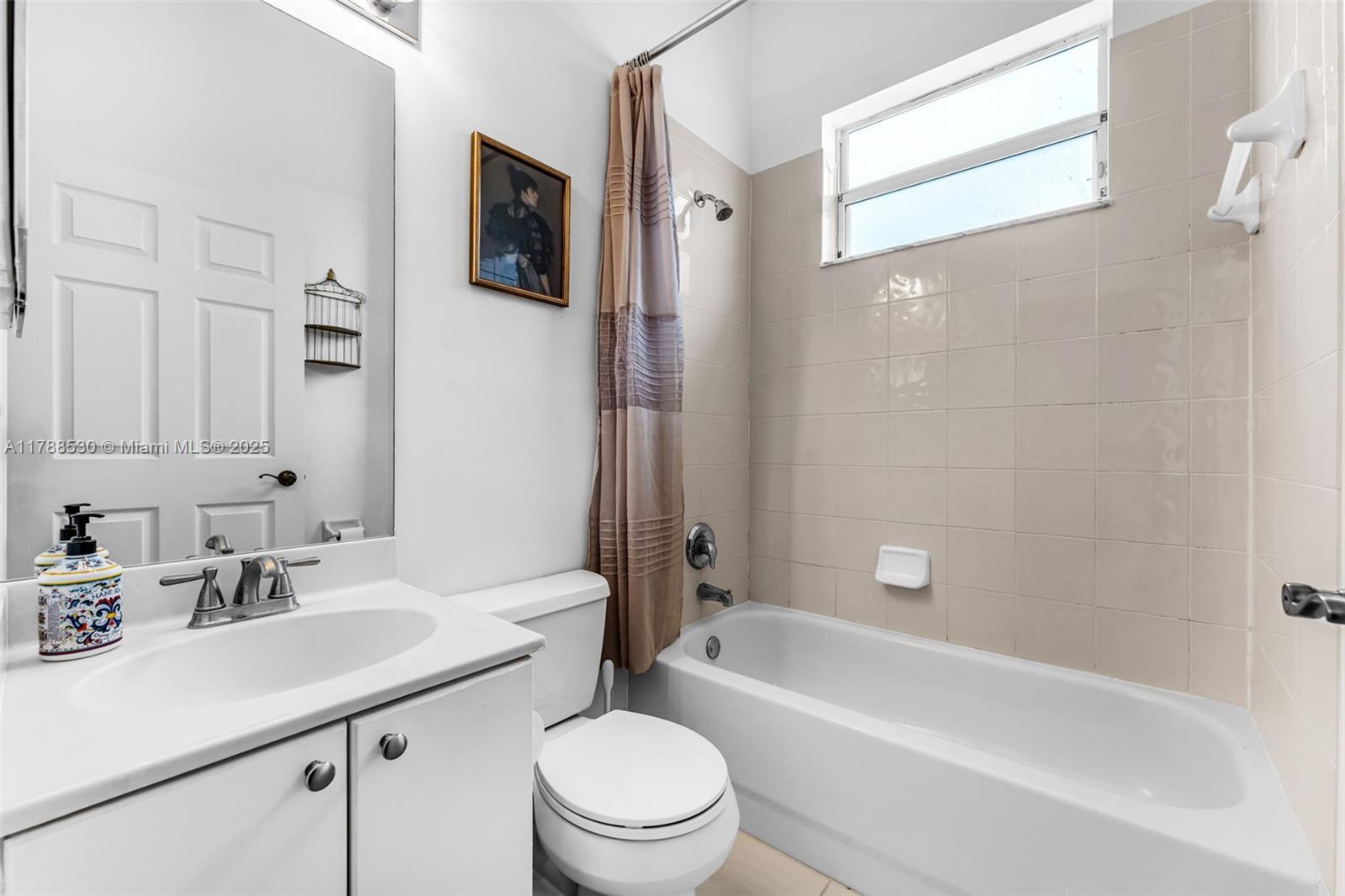 2819 Augusta Lane Homestead, FL 33035 - Photo 18 of 24 a bathroom with a sink a toilet a mirror a bathtub and shower