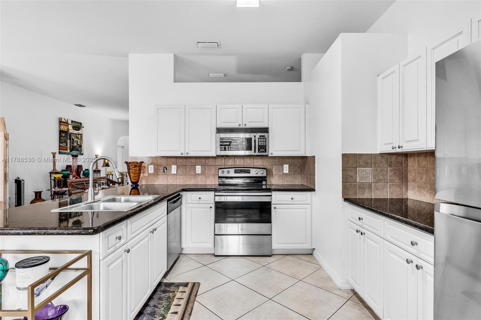 2819 Augusta Lane Homestead, FL 33035 - Photo 10 of 24 a kitchen with stainless steel appliances granite countertop a sink and a stove