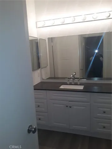 a bathroom with a sink and mirror