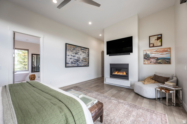 140 West Vista Road Kamas, UT 84036 - Photo 44 of 101 Recessed lighting, wood-finish flooring, and a modern fireplace with a white hearth