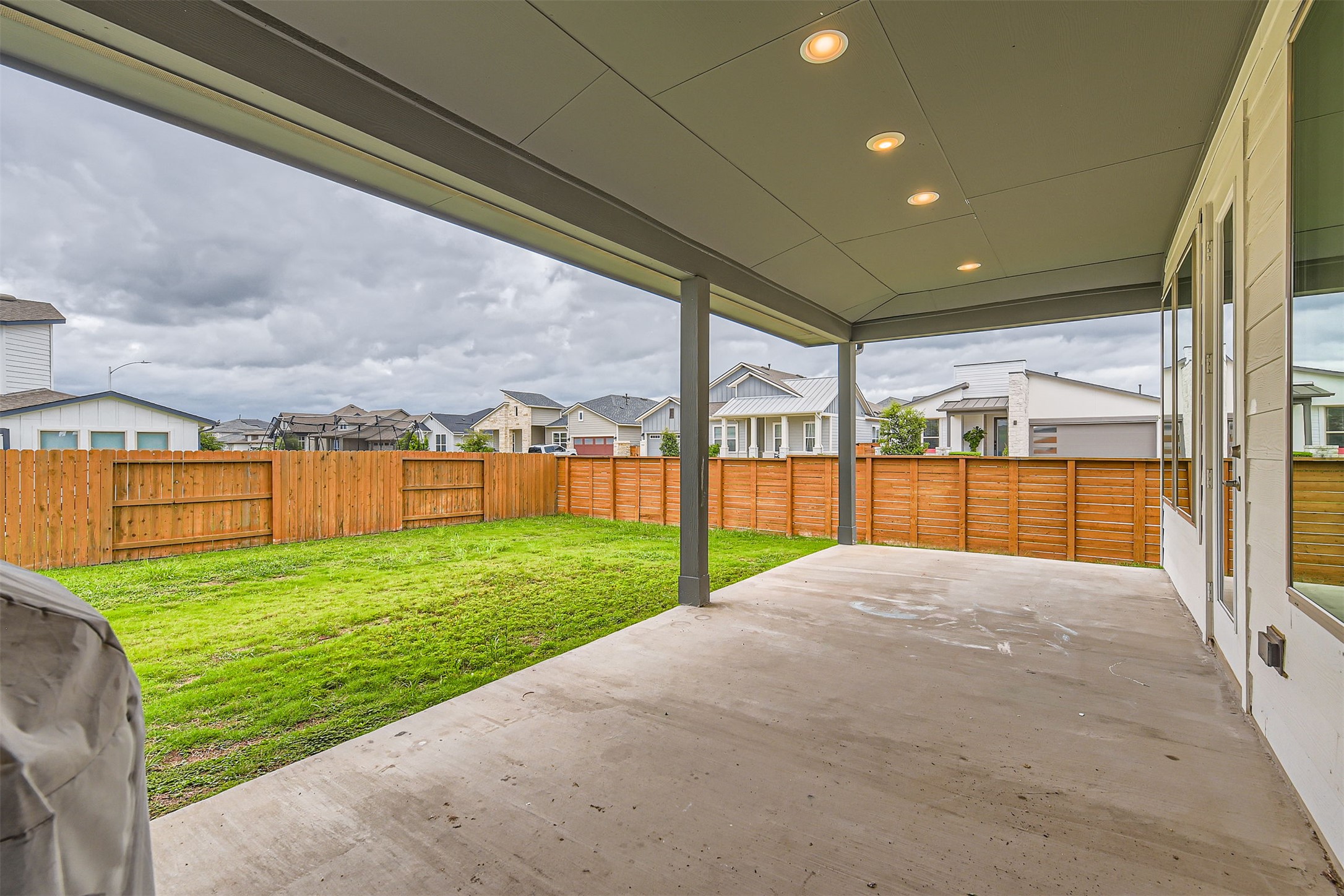 8313 Spire View Austin, TX 78744 - Photo 26 of 33 A spacious covered patio provides a delightful outdoor living extension to this residential property.