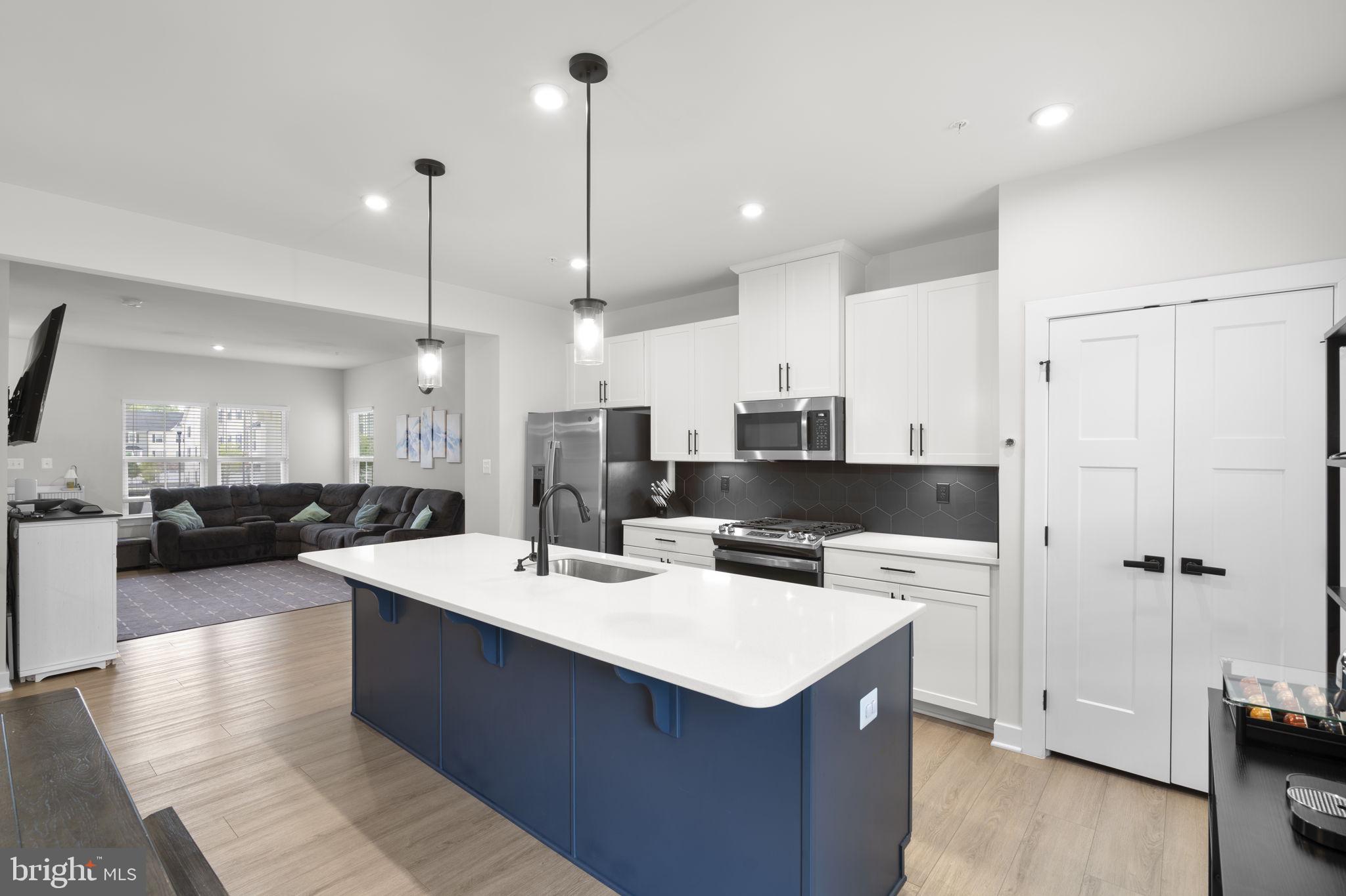 1713 Aurora Way Frederick, MD 21702 - Photo 13 of 57 a large kitchen with a counter top space a sink stainless steel appliances and cabinets