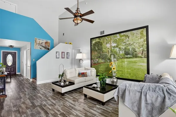 a living room with a bed furniture and a large window